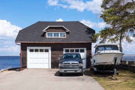 Roberval,  Canada - May 10, 2014: Quebec, a garage with car and boat on the St Jean lakeのeditorial素材