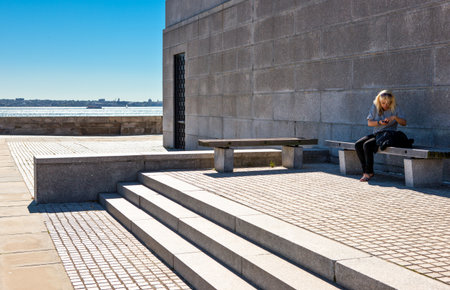 New York, U.S.A. - October 8, 20010: Liberty Island, a woman sitting on the basement of theLiberty Statueのeditorial素材