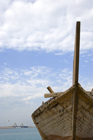 Bahrain, Manama, an old boat seen from the La Shaikh Isa Causewayの写真素材