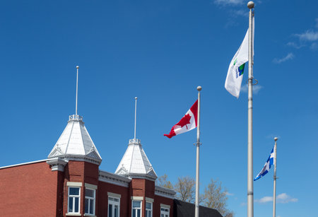 Trois Rivieres, Canada - May 12, 2014: Quebec, traditional houses and flags in De Casernes street.のeditorial素材