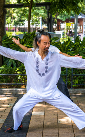Hong Kong, China - September 27,  2007: A Tai Chi training in the Victoria parkのeditorial素材