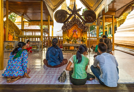 Yangon,  Myanmar - January 9, 2012:  Local  religious in prayer in the Swedagon Pagoda.のeditorial素材