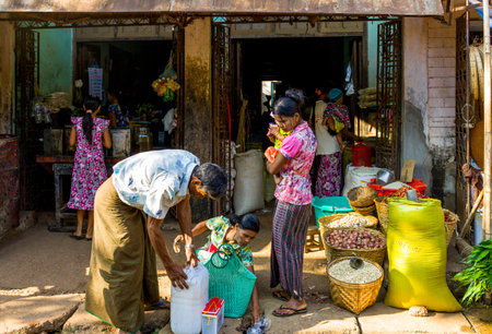 Yangon,  Myanmar - January 10, 2012:  Local people in the Hleku street market, along the road from Yangon to Bago.のeditorial素材