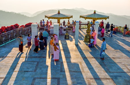 Kyaikhto,  Myanmar - January 10, 2012:  People and monks on a terrace of the sacred Buddhist mountain of Kyaikhtoのeditorial素材