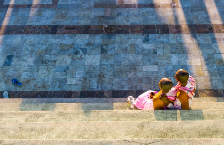 Kyaikhto,  Myanmar - January 10, 2012:  Two young monks on a terrace of the sacred Buddhist mountainのeditorial素材