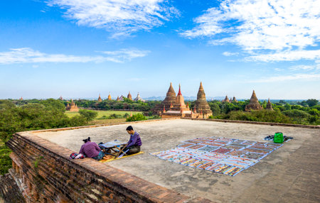 Bagan,  Myanmar - January 12, 2012:  Young people on a platform over the plain with thousand of 880-year old temple ruins.のeditorial素材