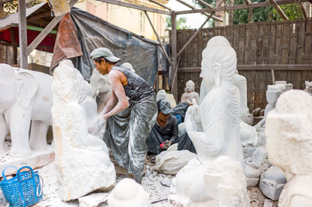 Mandalay,  Myanmar - January 13, 2012:  Marble workers prepearing Buddha statues.のeditorial素材