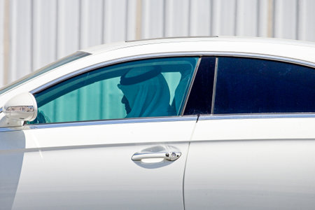 Doha,  Qatar - April 10, 2006: A local business man in a luxury car crossing the cty centerのeditorial素材