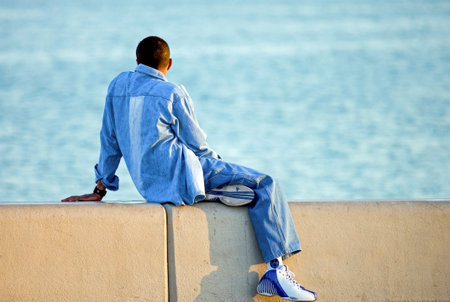 Doha,  Qatar - April 10, 2006: A young man looking at the sea from the La Corniche waterfrontのeditorial素材