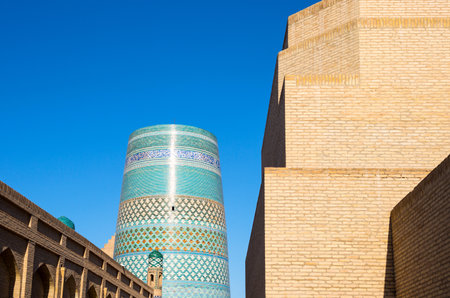 Uzbekistan, Khiva, the Kalta Minor minaret at Muhammad Amin Khan Madrassah seen from the country centerのeditorial素材