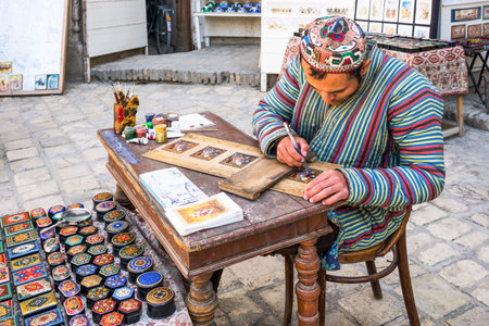 Buckara, Uzbekistan - Aprilr 16, 2014:  A craftsmen at work in the Taqi Sarrafon market in the old...
