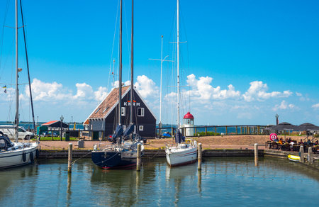 Marken, Holland - July 24, 2014: Waterland district, boats in the little harbour of the villageのeditorial素材