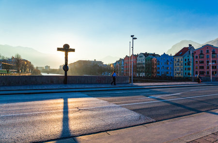 Innsbruck, Austria - February 8, 2010:  People walking on the Innbruck bridge at sunsetのeditorial素材