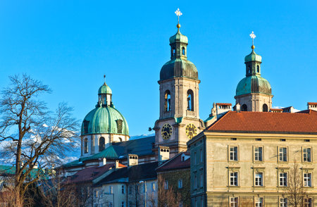 Austria, Tyrol, Innsbruck,  sunset view of  the San Giacomo Cathedral towers on the Inn river bankのeditorial素材