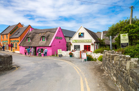 Calway, Ireland - August 4, 2013: Tourists between the  colored houses of the Doolin villageのeditorial素材