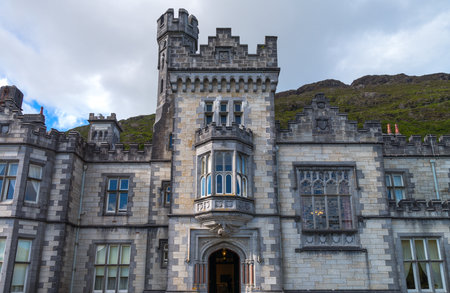 Calway, Ireland - August 4, 2013: Connemara area, upward view of the Kylemore abbey on the Pollacappul lakeのeditorial素材