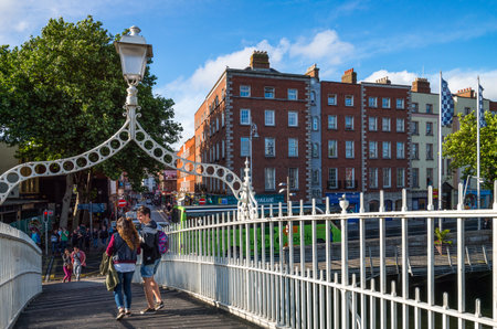 Dublin,  Ireland - July 31, 2013:  Young people on the Ha'penny bridge on the Liffey river, Temple Bar districtのeditorial素材
