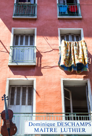 Toulon, France - June 27, 2009: The facade of a house of the old country center with the advertising of a cellos artisan.のeditorial素材