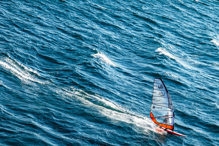Toulon, France - June 27, 2009:  A windsurf  performing in the sea in front of Tthe city.のeditorial素材