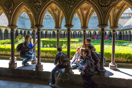 Mont St. Michel, France - May 22, 2012: Normandy, tourists taking pictures in the cloister of the abbey.のeditorial素材