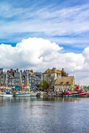 Honfleur, France - May 19, 2012: Normandy, traditional houses and boats in the old harbor basinのeditorial素材