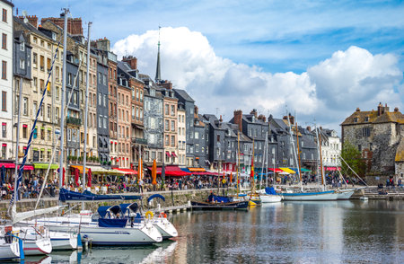 Honfleur, France - May 19, 2012: Normandy, traditional houses and boats in the old harbor basinのeditorial素材