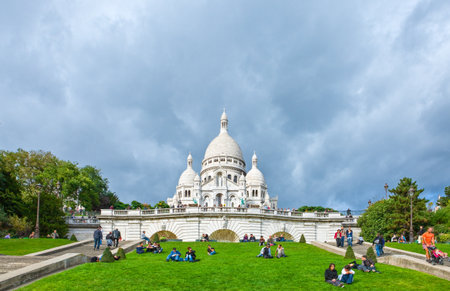 Paris,  France - October 4, 2009: Montmartre, people relaxing on the lawn with the Sacre Coeur church in the background.のeditorial素材