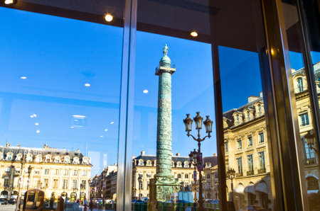 Paris,  France - September 29, 2011: Reflection of the column on a shopwindow in Place Vendome.