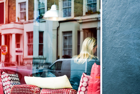 London, England - June 29, 2008:  A blonde lady on a store of Portobello street