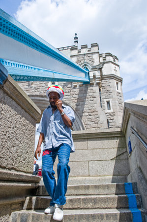 London, England - June 30, 2008: A man on the Tower Bridge stepsのeditorial素材