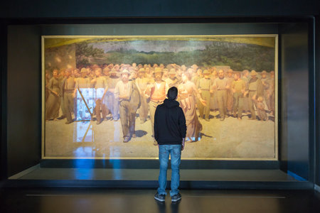 Milan, Italy - April 12, 2012: A bot in front of "The Fourth Estate" painting of Pellizza da Volpedo, in the Museum of the twentieth centuryのeditorial素材