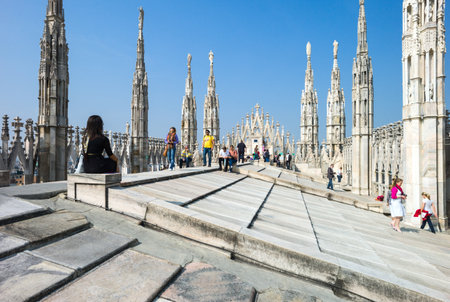 Milan, Italy - April 21, 2011: People between the spires and marle works of the Duomo cathedral rooftopのeditorial素材