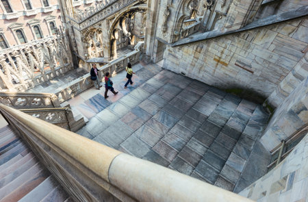 Milan, Italy - April 21, 2011: People between the spires and marle works of the Duomo cathedral rooftopのeditorial素材