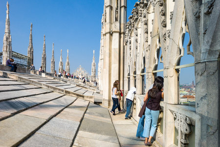 Milan, Italy - April 21, 2011: People between the spires and marle works of the Duomo cathedral rooftopのeditorial素材