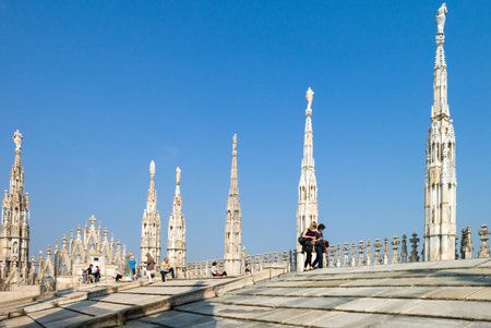Milan, Italy - April 21, 2011: People between the spires and marle works of the Duomo cathedral rooftopのeditorial素材