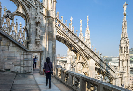 Milan, Italy - April 21, 2011: People between the spires and marle works of the Duomo cathedral rooftopのeditorial素材