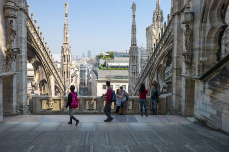 Milan, Italy - April 21, 2011: People between the spires and marle works of the Duomo cathedral rooftopのeditorial素材