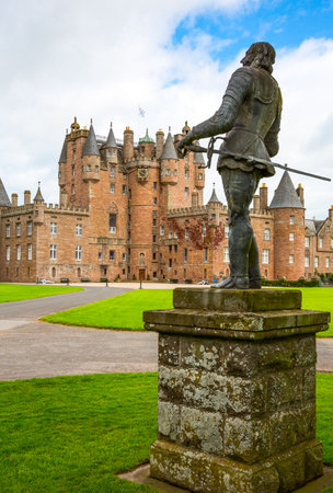 Angus, Scotland - July 27, 2012:  Fife area, the Glamis castle, childhood home of the Queen Elizabeth. In the foreground the King Charles II statue.のeditorial素材