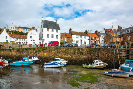 Crail, Scotland - July 26, 2012:  Fife area, fishing boats and yachts in the harbor at low tide.のeditorial素材