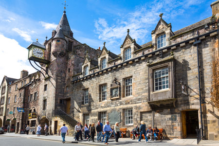 Edinburgh, Scotland - July 28, 2012: Royal Mile, Canongate, people under the Old Toolboth palace and clock.のeditorial素材