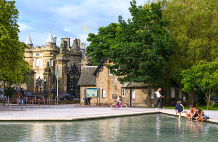 Edinburgh,  Scotland -  July 24, 2012:  A pond with boys in the square in fron of the Palace of Holyroodhouse.のeditorial素材
