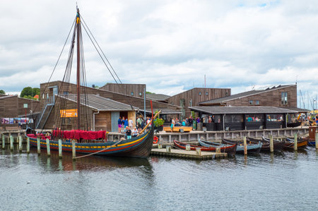 Roskilde, Denmark - July 23, 2015: Replicas of ancient boats and visitors outside the Viking Ship Museumのeditorial素材
