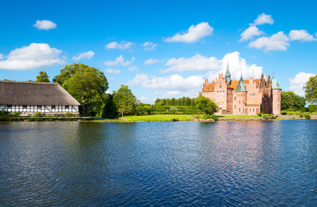 Kvaerndrup, Denmark - July 21, 2015: Panoramic view of the Egeskov castle on the lakeのeditorial素材