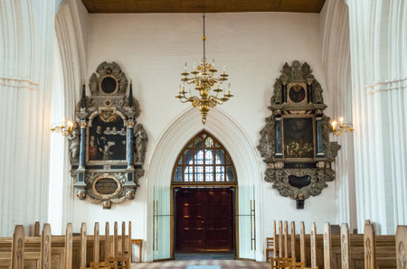 Odense, Denmark - July 21, 2015: Ancient paintigs to the sides of the inlet door of the gothic St. Canute's Cathedralのeditorial素材