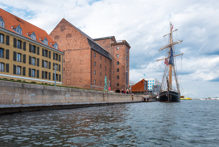 Copenhagen, Denmark - July 22, 2015: Ancient sailing ship and the David statue in the port...