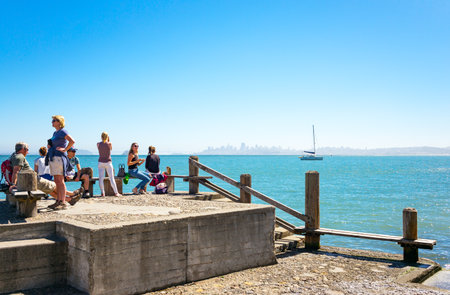 Sausalito, USA - September 23, 2015: Tourists on a pier looking at the bay with the San Francisco skyline in the backgroundのeditorial素材