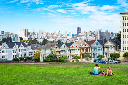 San Francisco, USA - September 24, 2015:  The colored traditional houses of Alamo square with the cityscape on backgroundのeditorial素材