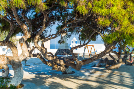Greece, Santorini, view of the small bell tower of an Orthodox church in a suqare of Oia villageの写真素材