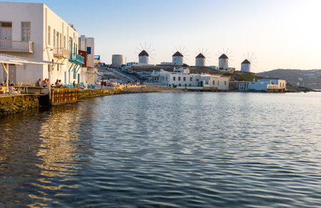 Mykonos, Greece - October 15, 2012:  View of the historic windmills from the Little Venice area at sunsetの写真素材