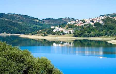 Italy, Gran Sasso National Park, the Campotosto lake with the village in backgroundの写真素材